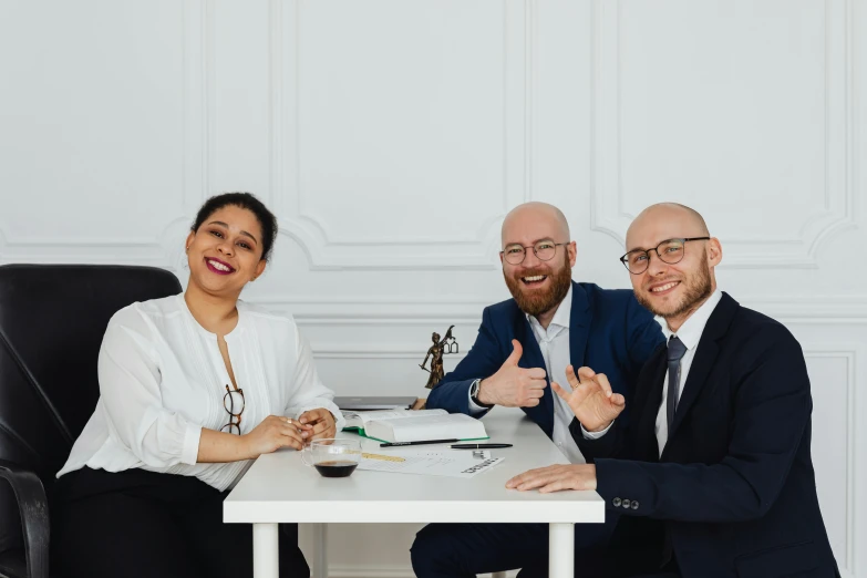 three business people sitting at a table giving a thumbs up, inspired by Albert Paris Gütersloh, pexels contest winner, figuration libre, demna gvasalia, white backround, lawyer, dasha taran