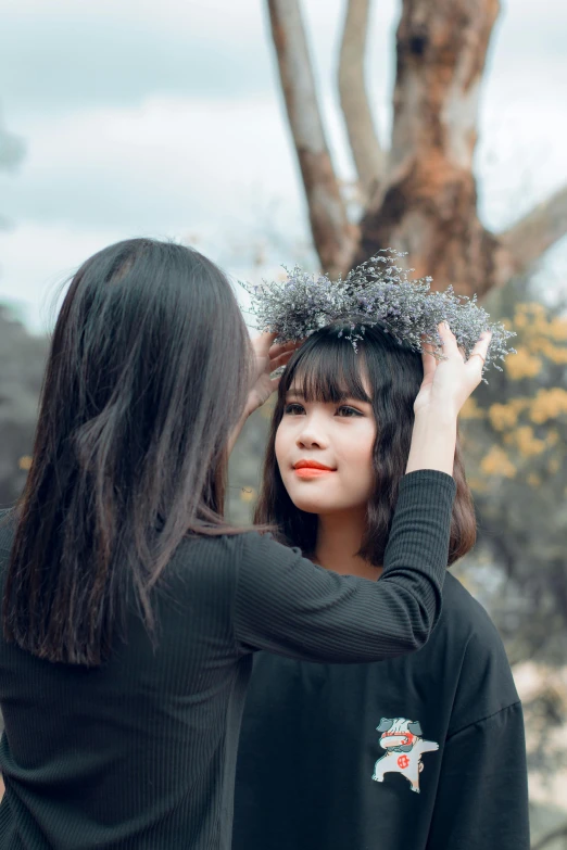 a woman putting a crown on another woman's head, pexels contest winner, aestheticism, medium length black hair, autumn season, south east asian with round face, infrared hair