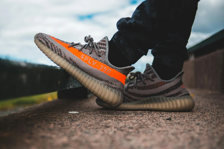 a person standing on top of a skateboard, unsplash contest winner, hyperrealism, yeezy, orange neon stripes, yzy, sitting down