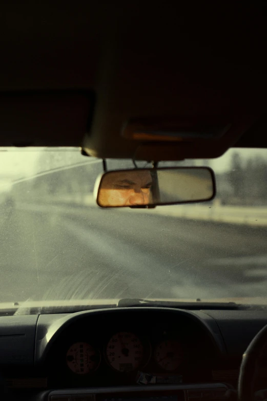 a view from the front seat of a car going down a road