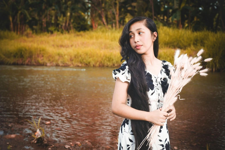 a woman standing in front of a body of water, a portrait, inspired by Ruth Jên, unsplash, hurufiyya, floral clothes, avatar image, young asian girl, portrait n - 9