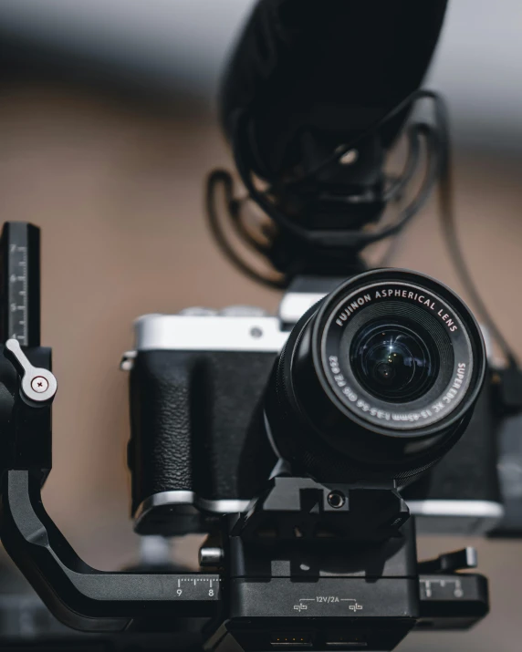 a close up of a camera on a tripod, pexels contest winner, video art, anamorphic lenses, fujifilm x - pro 2, a high angle shot, looking towards camera