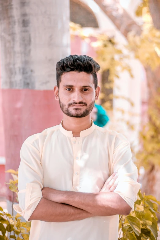 a man with black hair and beard posing for the camera