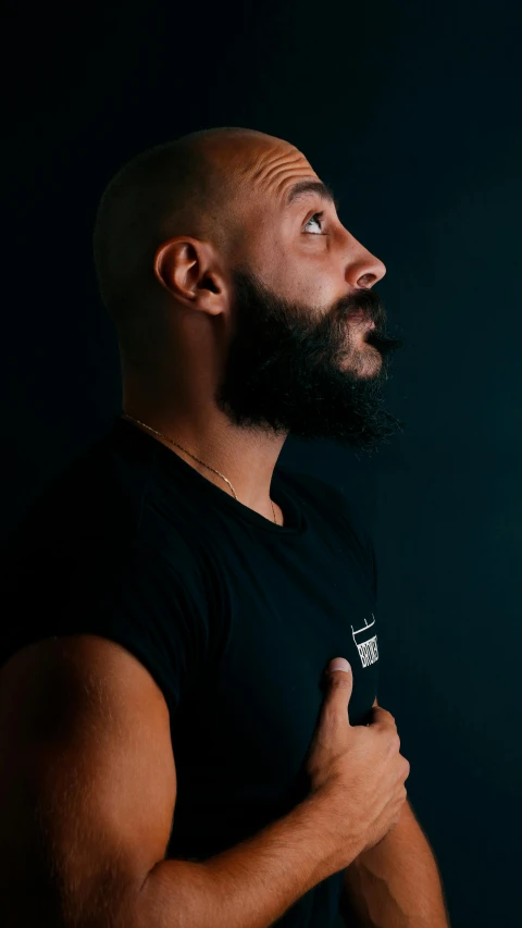 a man with a beard and a black shirt, pexels contest winner, les nabis, of a muscular, profile image, color photograph, commercial photo