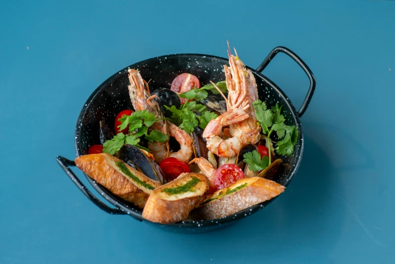 a pan filled with food sitting on top of a blue table, crustacean, thumbnail, amagaitaro, bowl