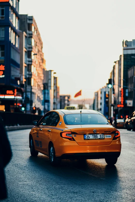 a taxi is waiting for its driver to cross the street