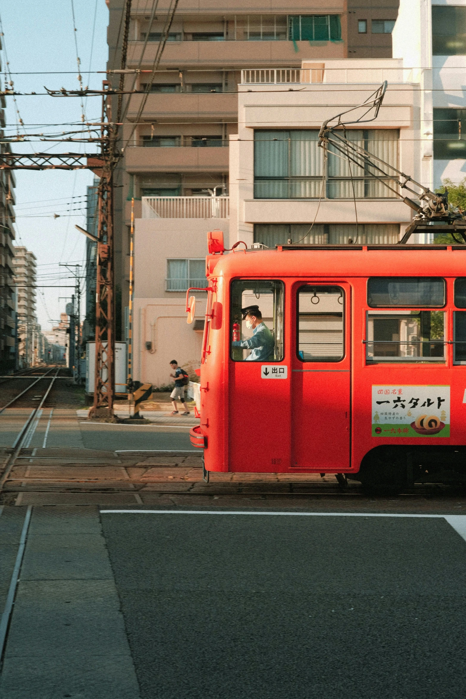 an orange train engine stopped in front of the loading platform