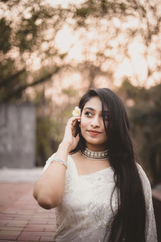 a woman in a white dress talking on a cell phone, by Max Dauthendey, trending on pexels, beautiful young himalayan woman, white petal, halfbody headshot, switch