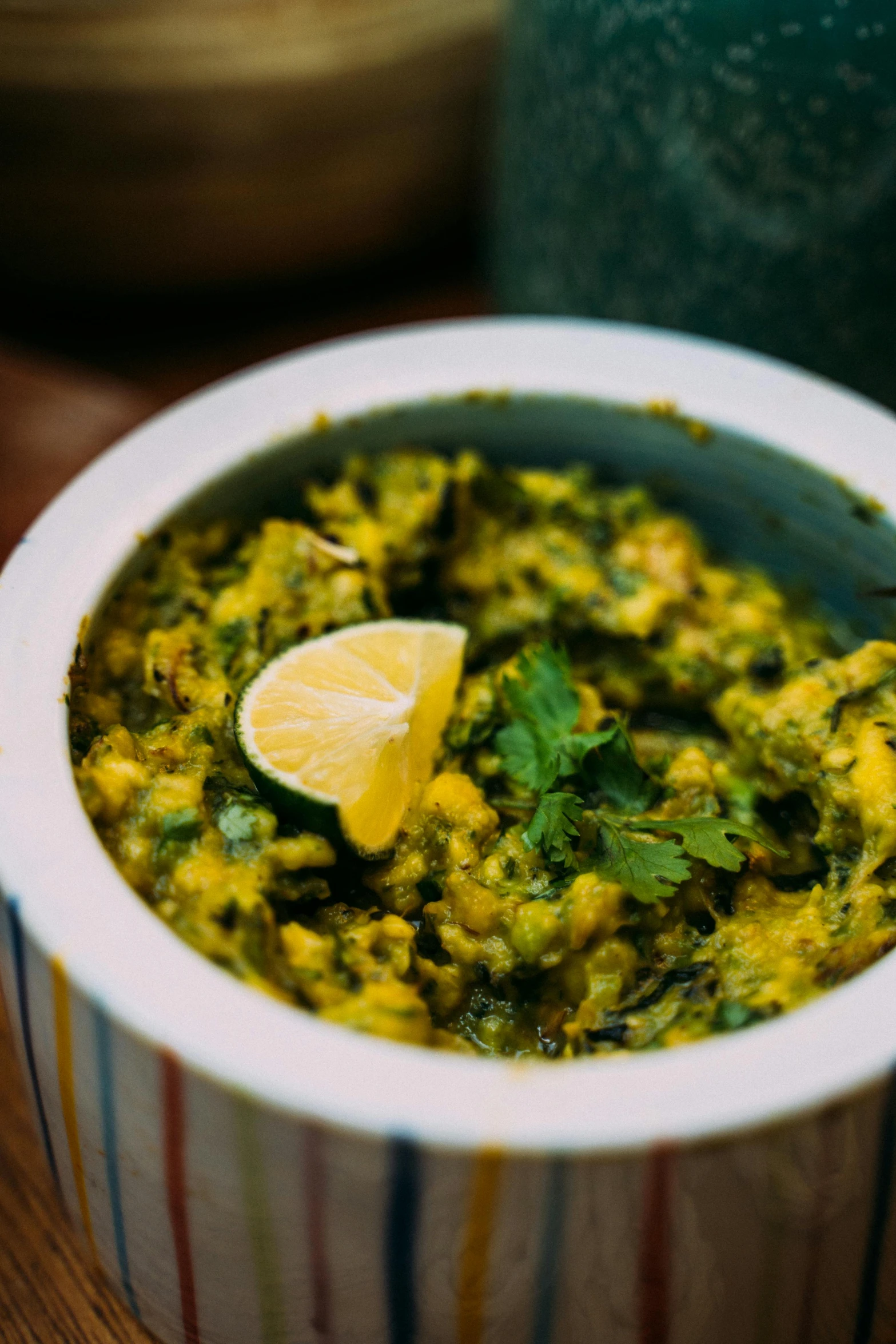 a close up of a bowl of food on a table, hurufiyya, yellow and greens, calcutta, jaime jasso, the best