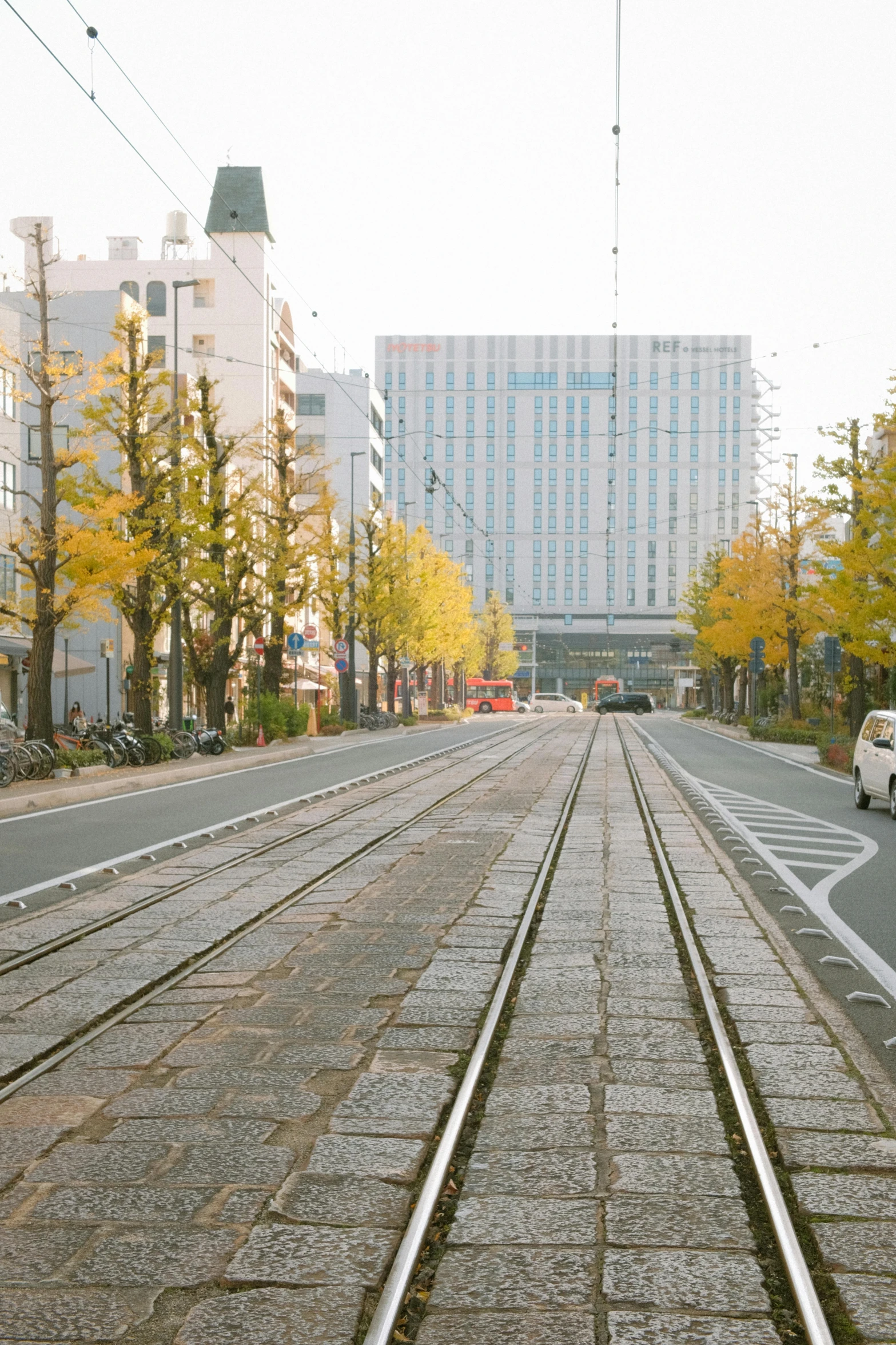 a empty train track runs through the center of a city