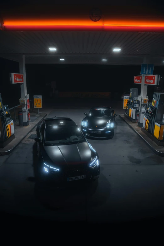 a couple of cars parked in a gas station