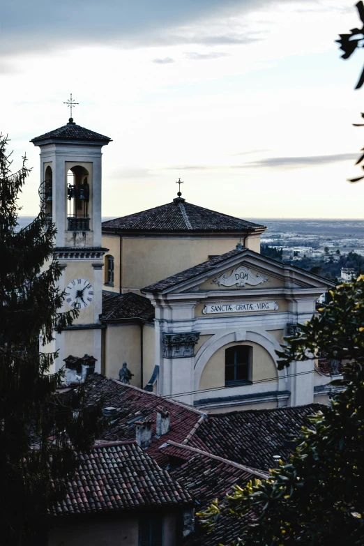 a view of a church from the top of a hill, renaissance, classicism style, valle dei templi, with dark trees in foreground, instagram picture