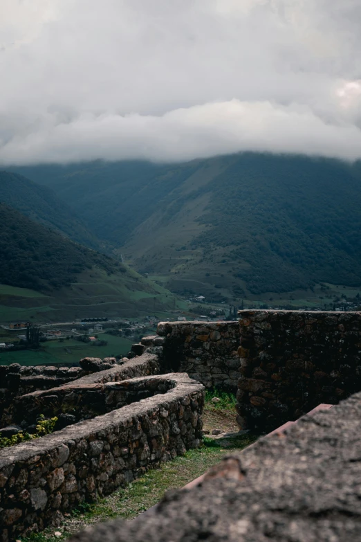 a stone wall and a small stone building