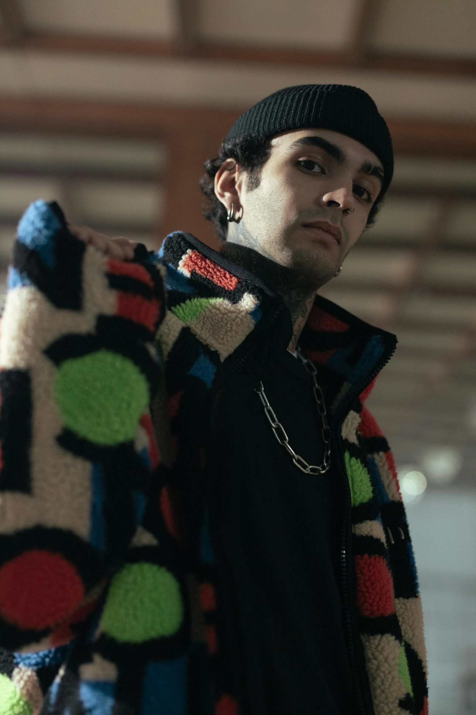 a man holding an item with multi colored circles on it