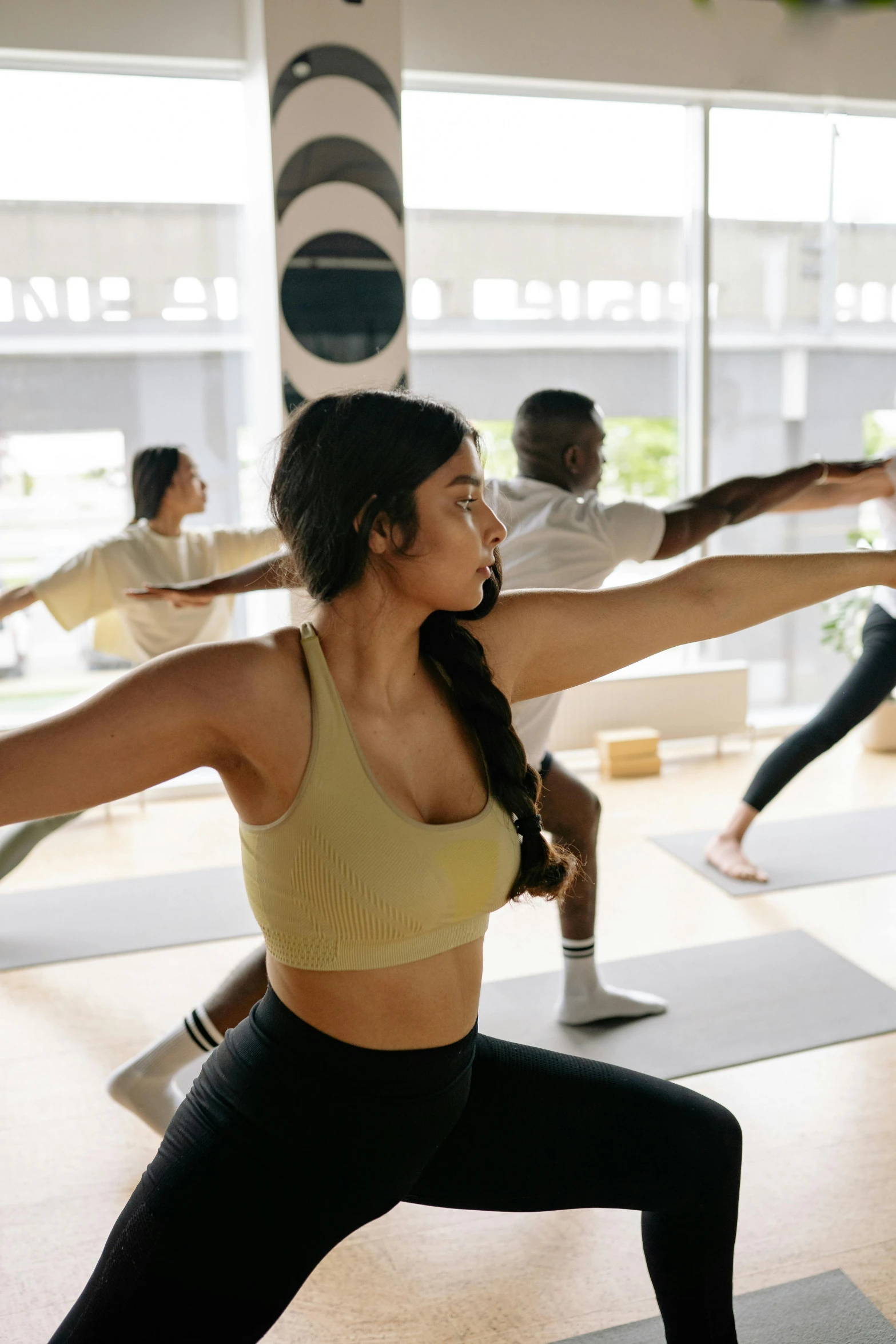 a group of people doing yoga with yoga mats on the floor