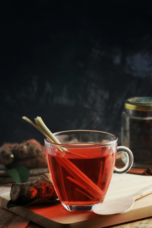 a cup of tea sitting on top of a wooden table, a portrait, inspired by Wlodzimierz Tetmajer, pexels, renaissance, cinnamon, red, stems, thumbnail