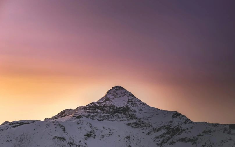 a po of the snow capped mountain top at sunset