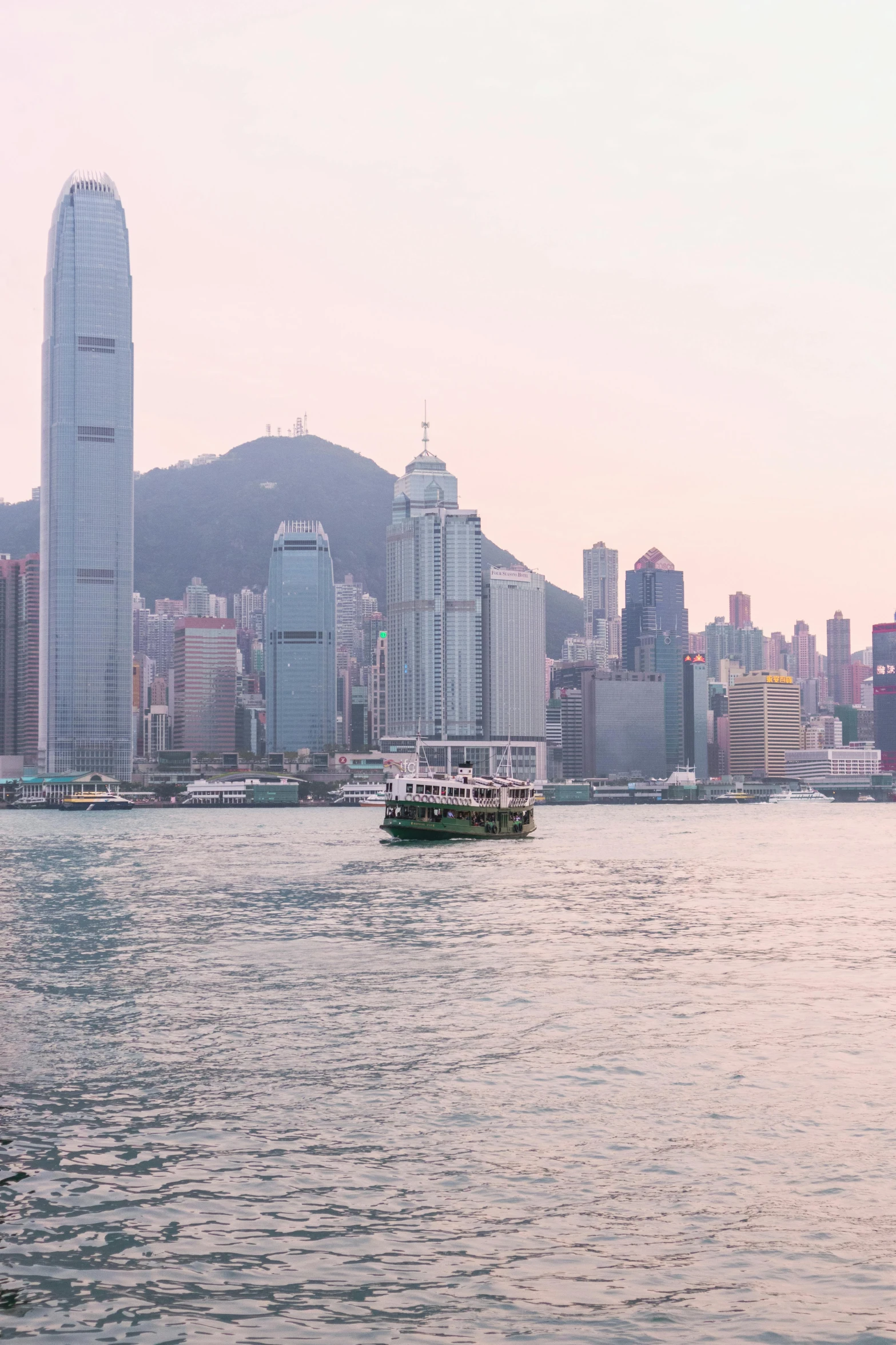 a large body of water with a city in the background, by Patrick Ching, street of hong kong, water surrounds the ship, pink hues, small chin