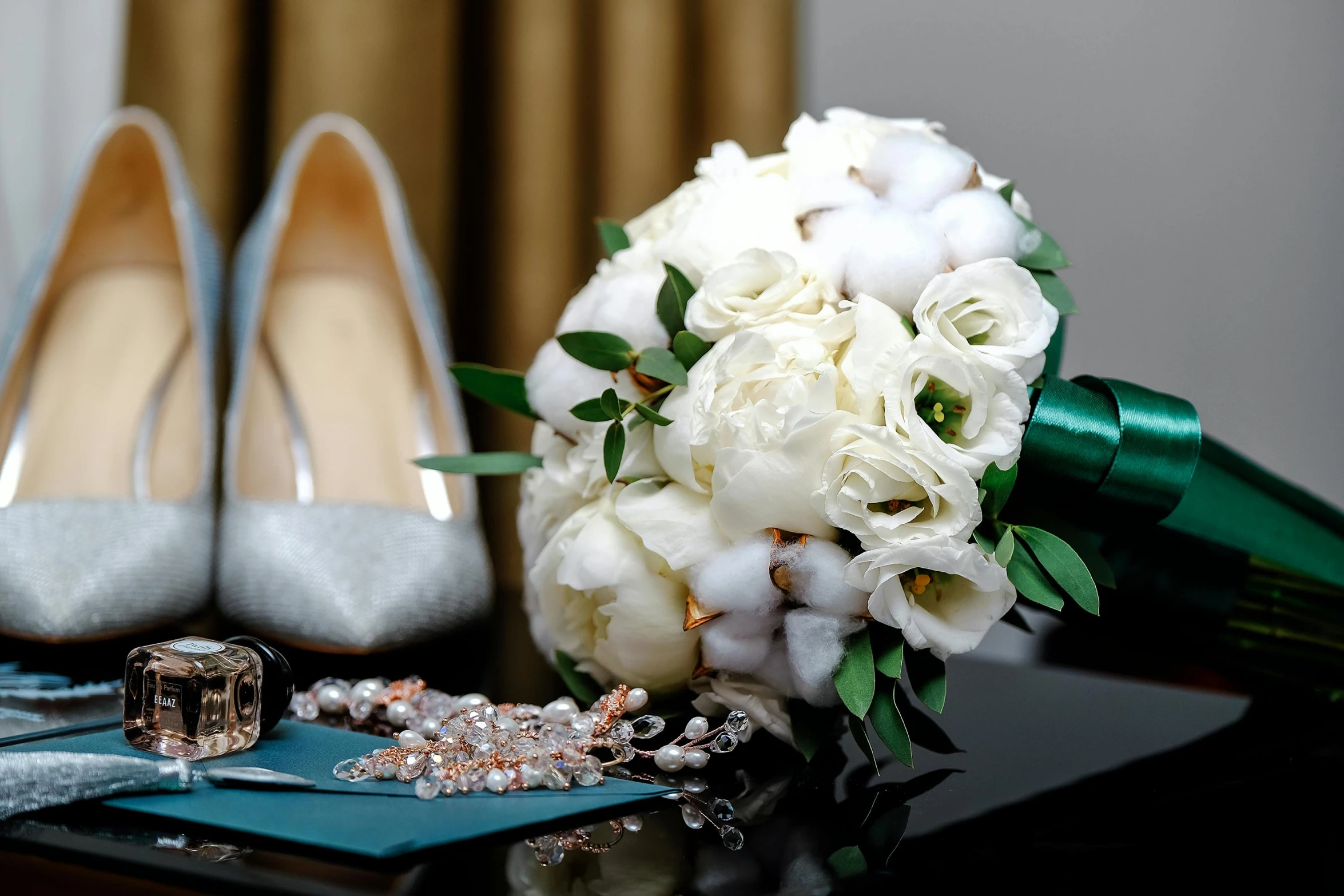 a bridal bouquet sitting next to wedding shoes