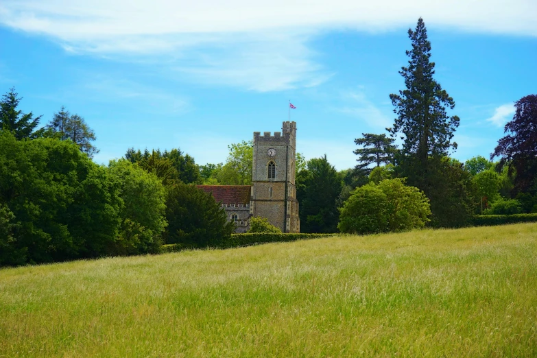 a tall tower sitting in the middle of a lush green field, esher, slide show, house on a hill, the narthex