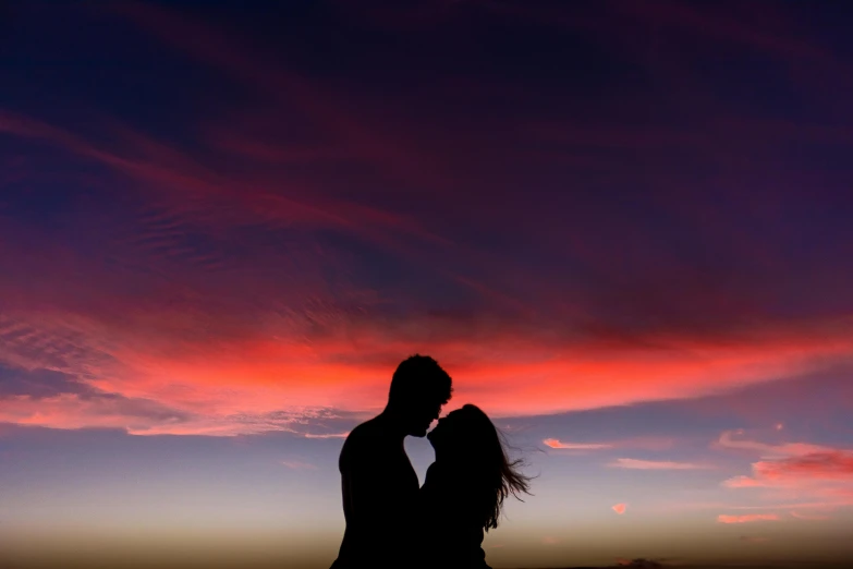 a couple standing next to each other in front of a sunset, pexels contest winner, romanticism, sherbert sky, profile image, shaped picture, red hues