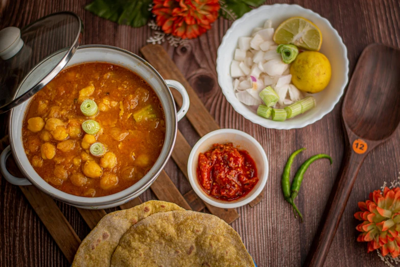 a wooden table topped with bowls of food, a portrait, pexels contest winner, dau-al-set, indian, background image, square, stew