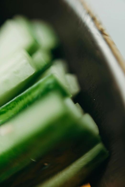 a close up of sliced cucumbers in a bowl, by Carey Morris, unsplash, coated pleats, made of glazed, green lightsaber, banner