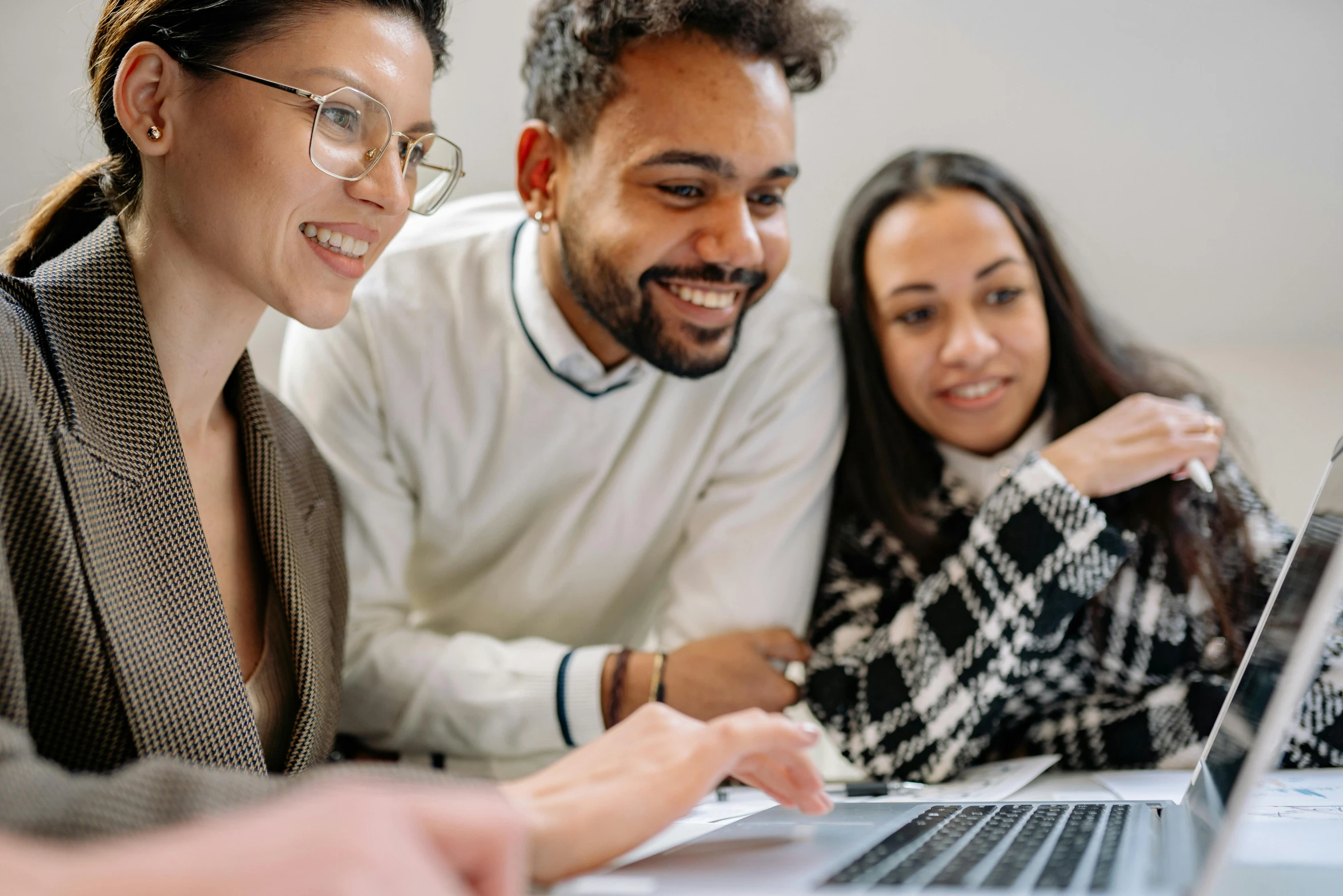 a group of people sitting around a laptop computer, profile image, varying ethnicities, smiling at each other, background image