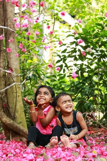 a couple of kids that are sitting in the grass, subtropical flowers and plants, kuntilanak on tree, smiling playfully, photograph taken in 2 0 2 0