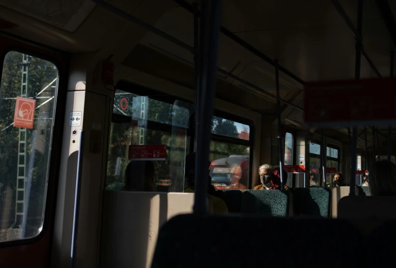 a bus filled with people sitting next to each other, unsplash, hyperrealism, back light, train window, ultra realistic 8k octan photo, summer morning light