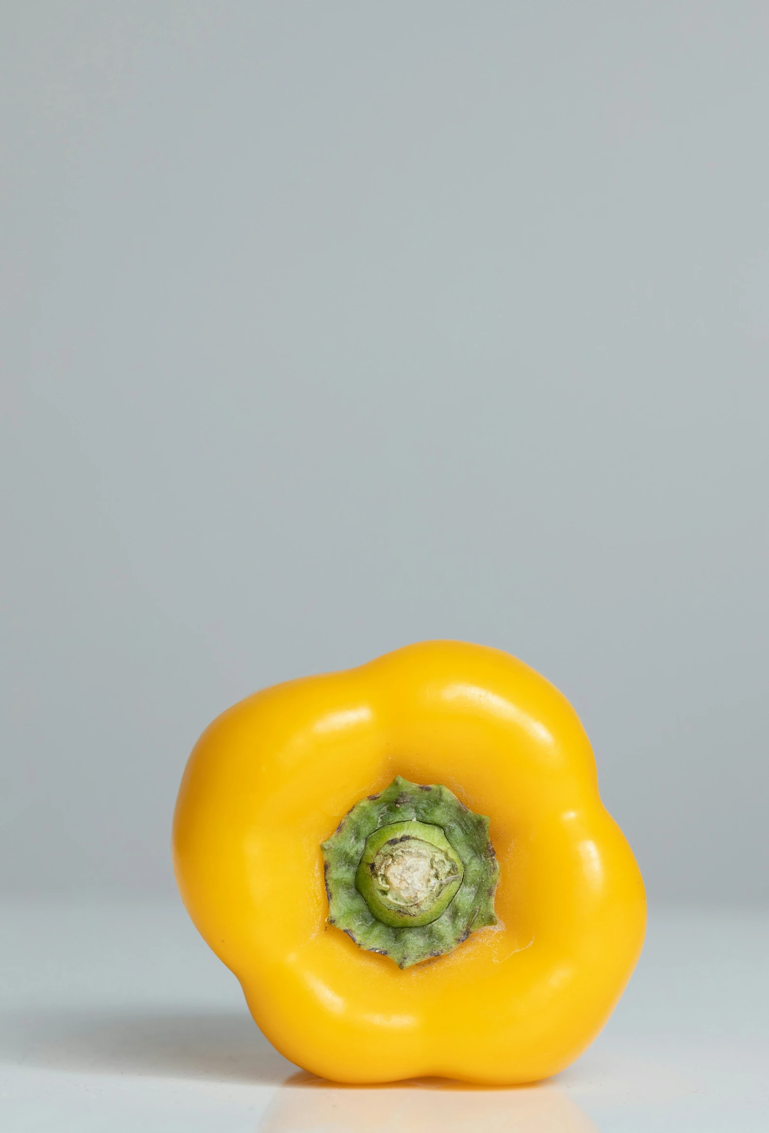 a yellow bell pepper sitting on top of a table, by Jan Theuninck, 9 0 mm studio photograph tiny, veggies, jaime jasso, medium-shot