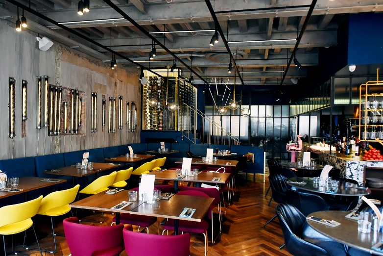 a dining room with blue walls and wooden floors