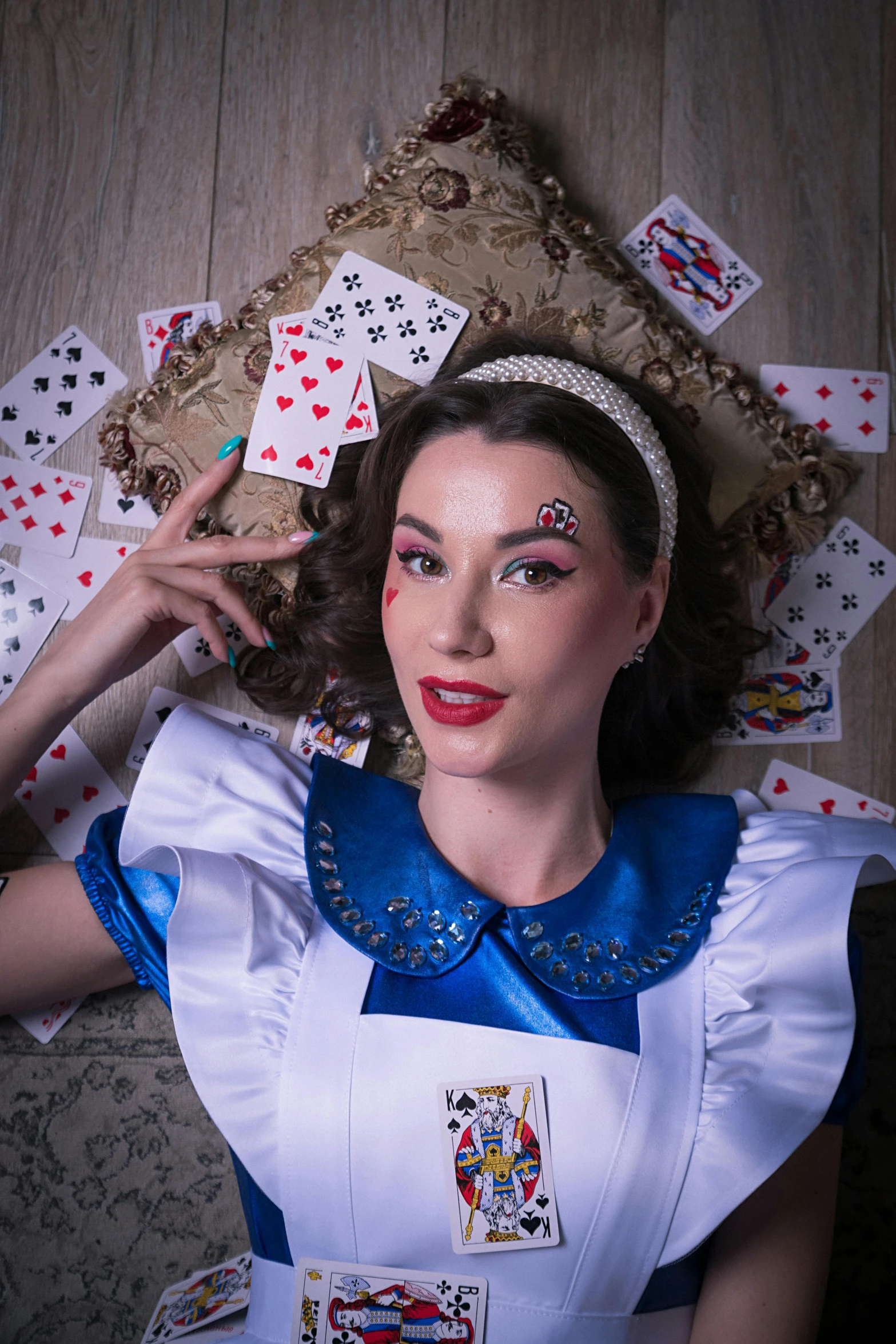 a woman in a white dress is surrounded by playing cards, a portrait, inspired by Alice Rahon, pexels contest winner, pop surrealism, costume with blue accents, square, ( ( theatrical ) ), pinup