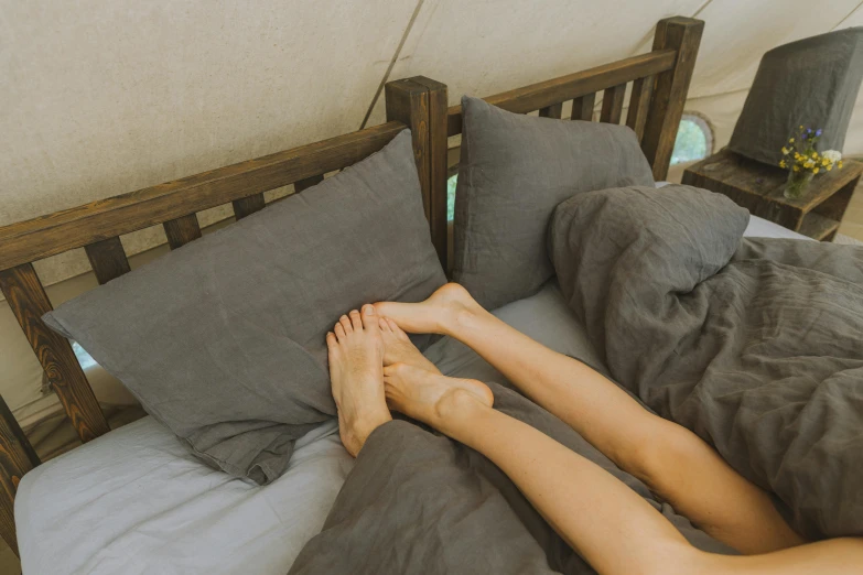 someone laying down on their bed in a yurt