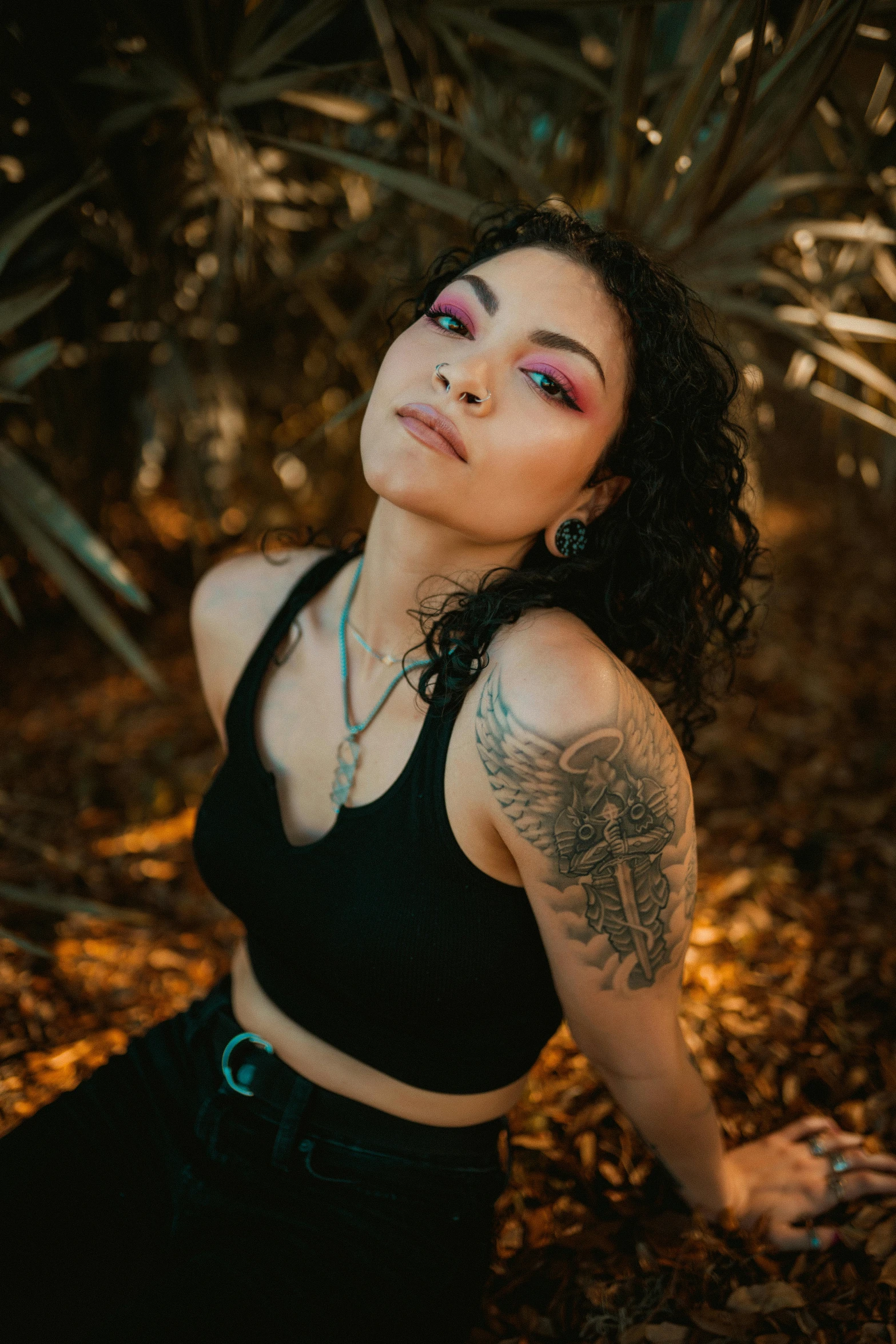 a woman with tattoos sitting on the ground, trending on pexels, renaissance, wearing a cropped black tank top, mixed race woman, in a tree, pastel'