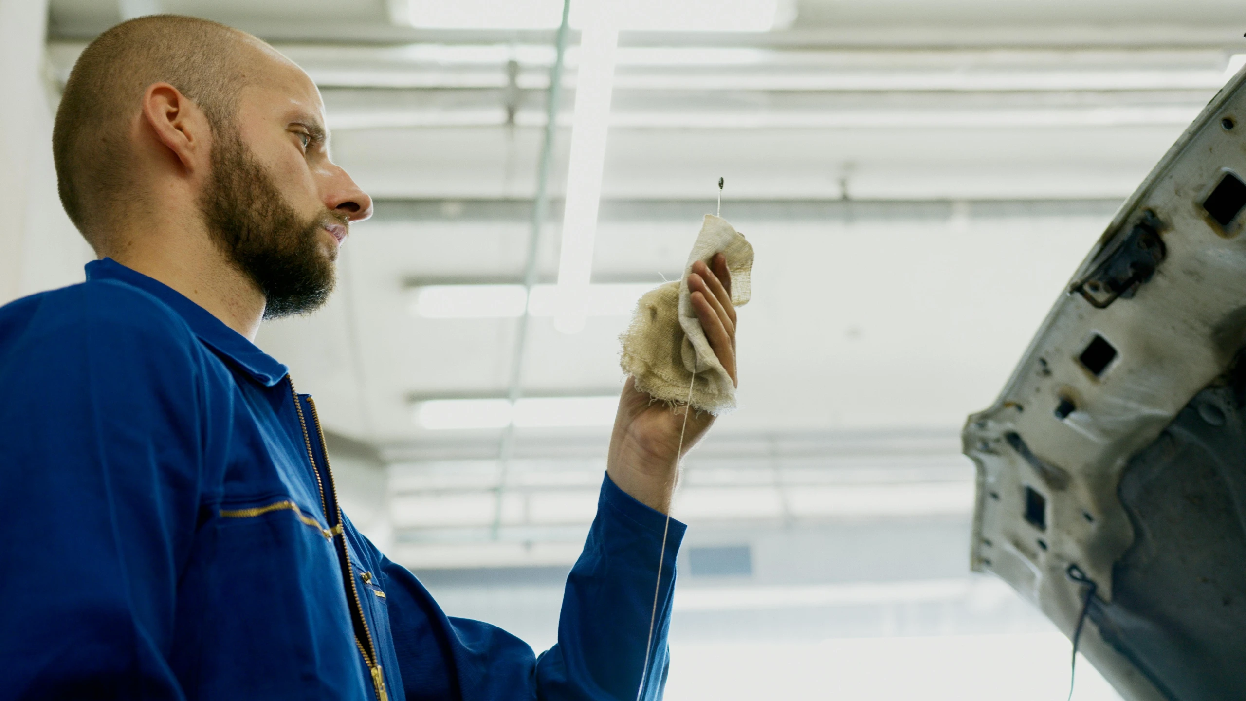 a man working on a car in a garage, a portrait, by Jakob Gauermann, arbeitsrat für kunst, holding a goat head staff, avatar image, engineering, mid shot photo