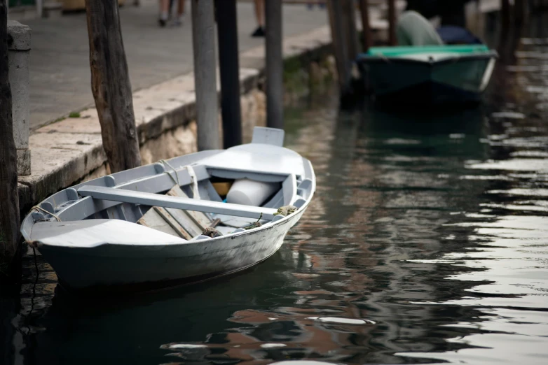 a row boat sitting on top of a body of water, by Patrick Pietropoli, pexels contest winner, photorealism, venice biennale, promo image, 2022 photograph, small dock