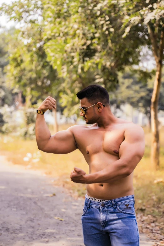 a man posing on the side of a road for a picture