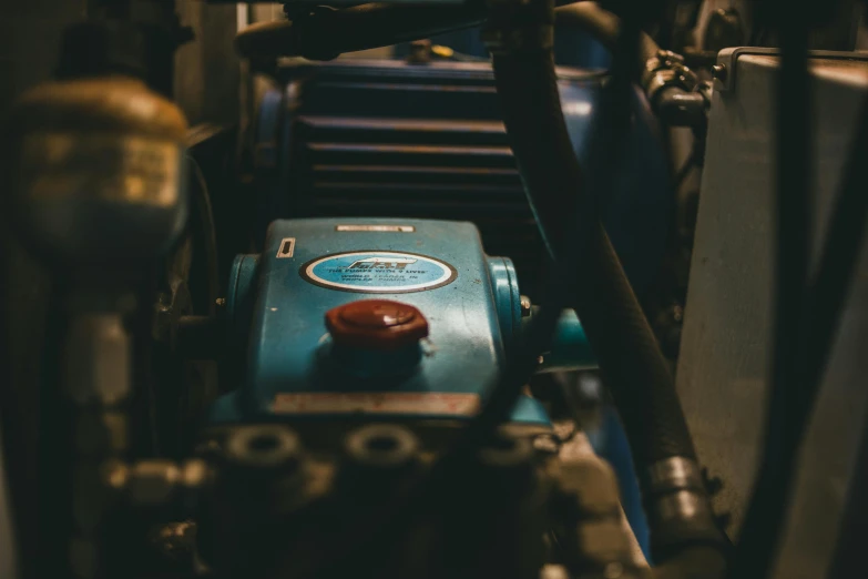 a machine that is sitting inside of a building, unsplash, large blue engines, vintage colours, close up photograph, petrol aesthetic