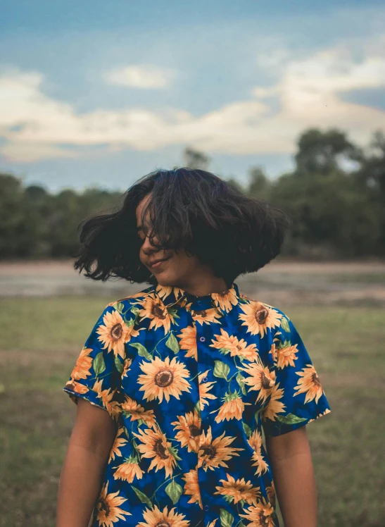 a woman standing in a field with sunflowers on her shirt, trending on unsplash, swirling black hair, retro style ”, avatar image, ( ( dark skin ) )