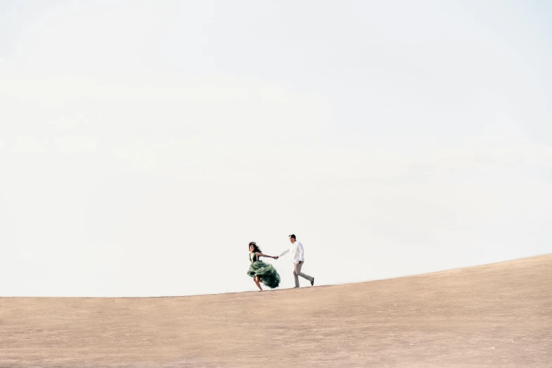 a couple of people that are walking on a hill, by Daren Bader, pexels contest winner, minimalism, levitating sand, white bg, a green, wedding photo