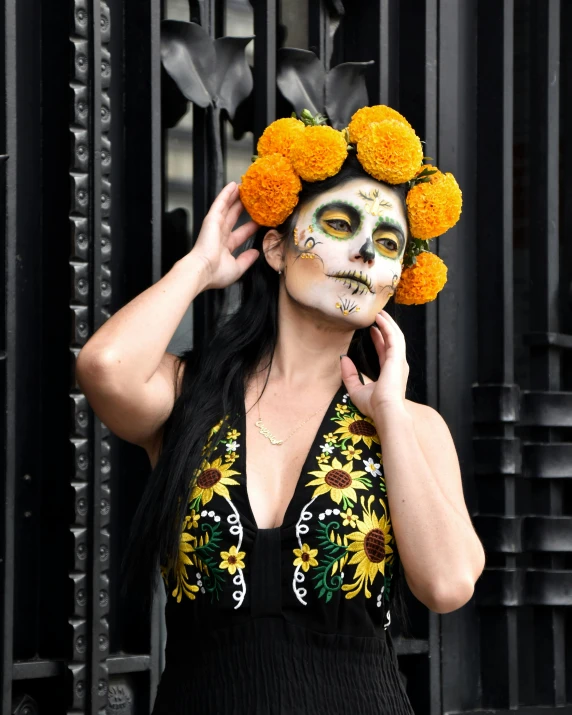 a woman in a day of the dead costume, inspired by Kahlo, pexels contest winner, yellow overall, floral crown, black and orange colour palette, lgbtq