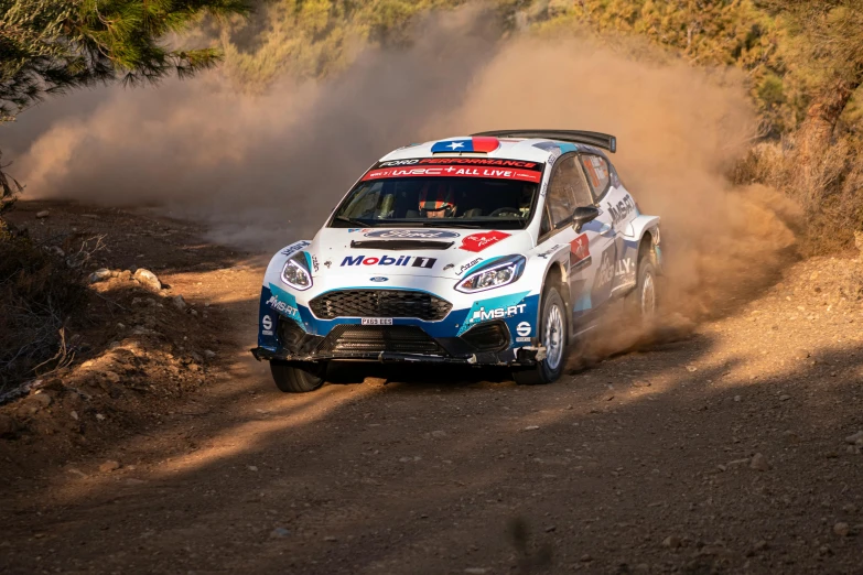 a white and blue car driving on dirt road