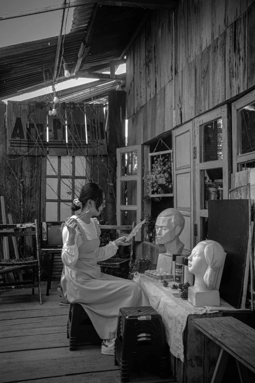 a black and white photo of a woman working on a sculpture, a black and white photo, inspired by Juan Luna, process art, ao dai, in a old house. hyper realistic, cinematic. by leng jun, trending photo