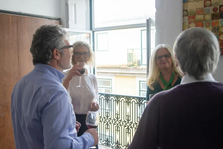 a group of people standing next to each other, private press, lisbon, wine, looking out, profile image