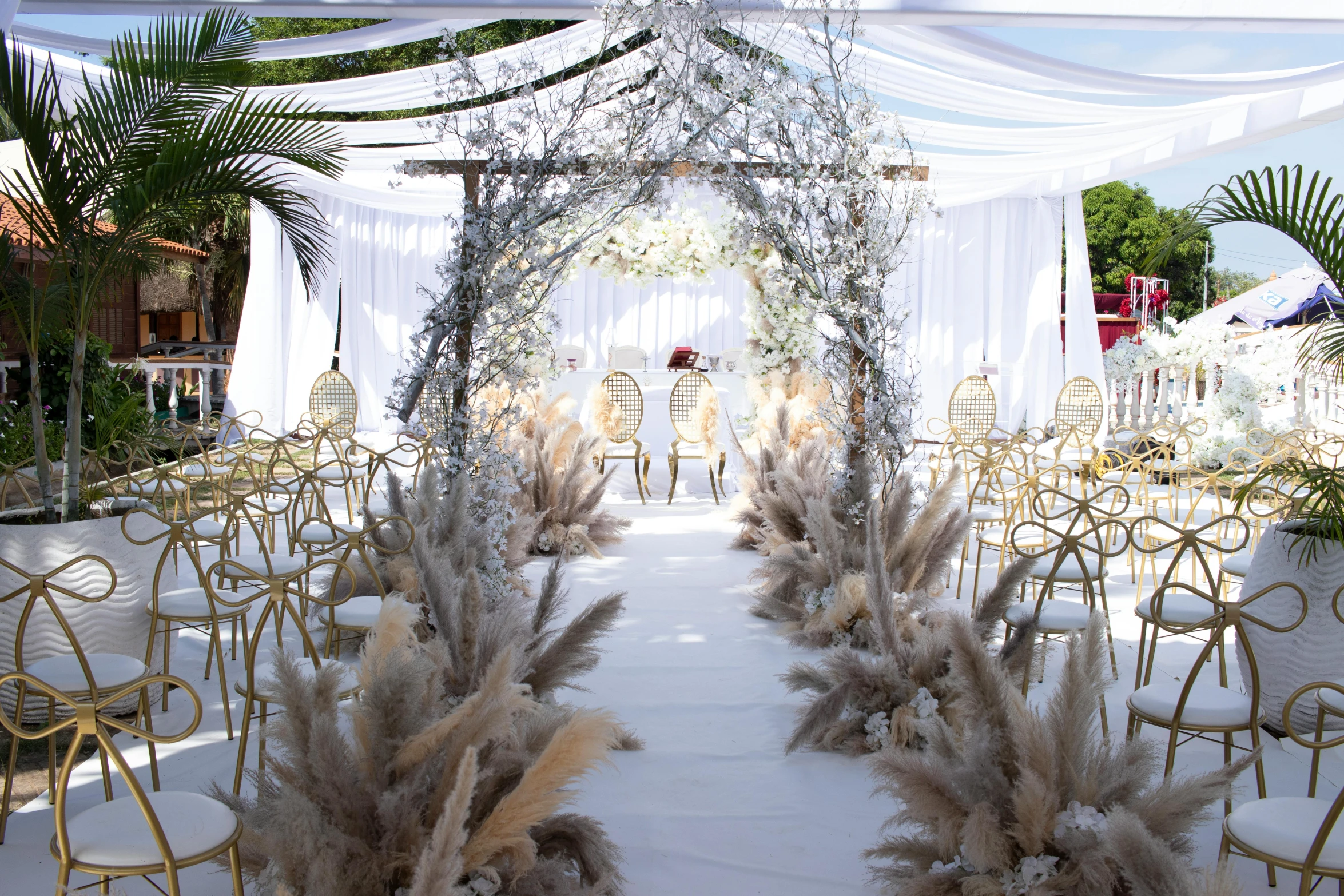 a white and gold decorated tent set up for a wedding