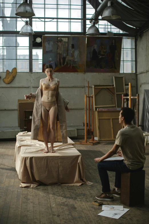 a woman standing on top of a bed next to a man, a hyperrealistic painting, master life drawing, sitting on a lab table, still from a live action movie, alessio albi and shin jeongho