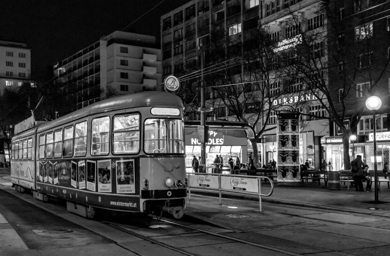 a trolly going down the street on a night time