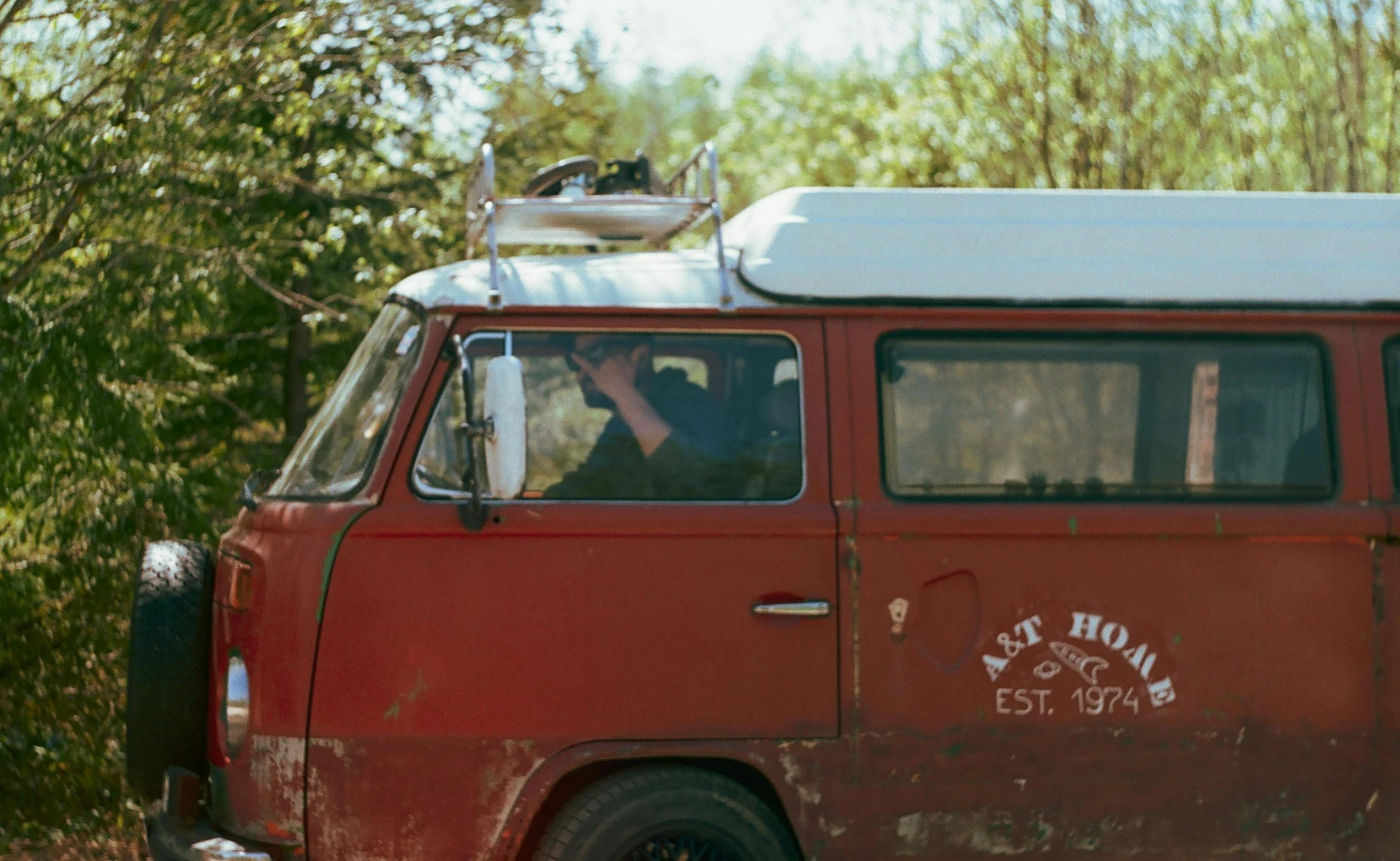 a red van with a surfboard on top of it, a portrait, pexels contest winner, auto-destructive art, soft top roof raised, cottage hippie naturalist, brown, aleksander rostov