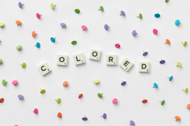 the word colored spelled in scrabbles on a white background, inspired by Ellsworth Kelly, trending on unsplash, color field, led color, beige colors, colorful adornments, setteidreams colour design
